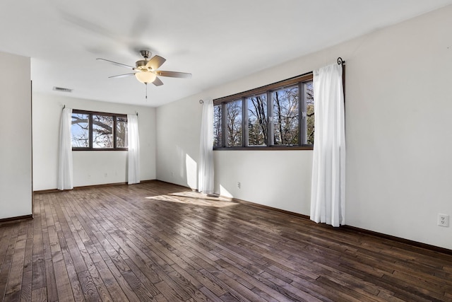 spare room with ceiling fan and dark wood-type flooring