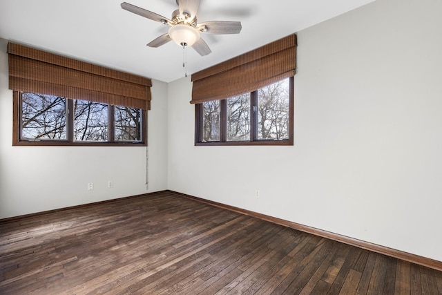 unfurnished room with ceiling fan and dark hardwood / wood-style floors