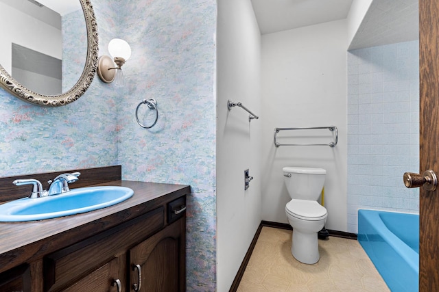 bathroom with toilet, a tub to relax in, and vanity