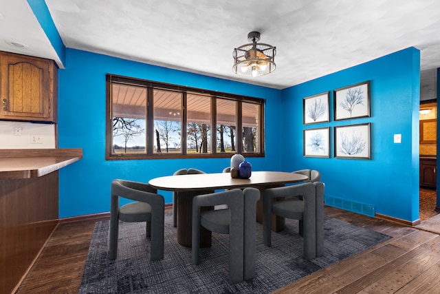 dining area featuring dark wood-type flooring