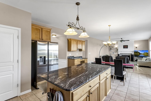 kitchen featuring pendant lighting, light tile patterned floors, stainless steel fridge with ice dispenser, and a kitchen island