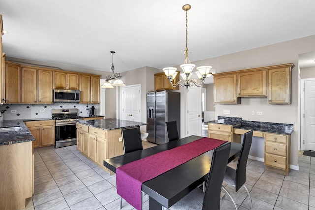 kitchen with stainless steel appliances, a kitchen island, light tile patterned floors, and decorative light fixtures