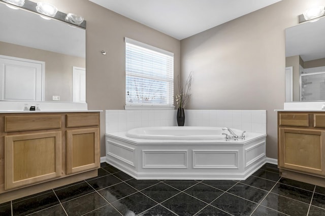 bathroom featuring plus walk in shower, vanity, and tile patterned flooring