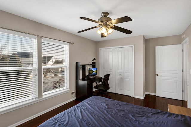 bedroom featuring dark hardwood / wood-style floors, a closet, and ceiling fan