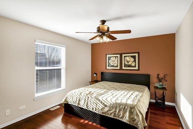 bedroom featuring ceiling fan and dark hardwood / wood-style flooring