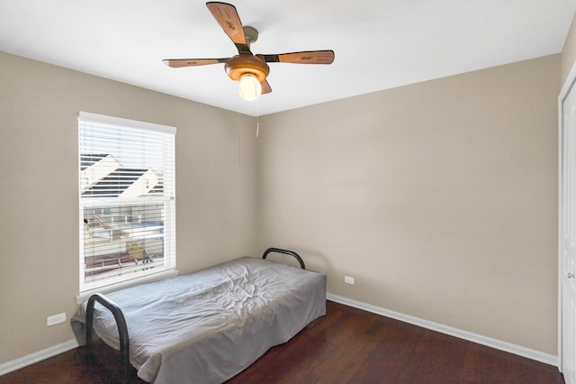 bedroom with ceiling fan and dark hardwood / wood-style floors