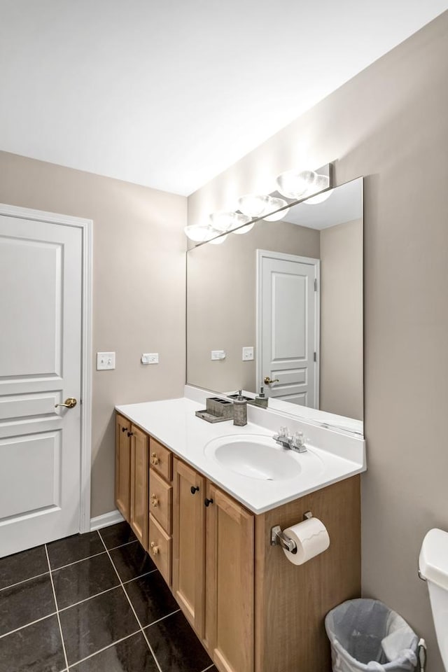 bathroom featuring toilet, vanity, and tile patterned flooring