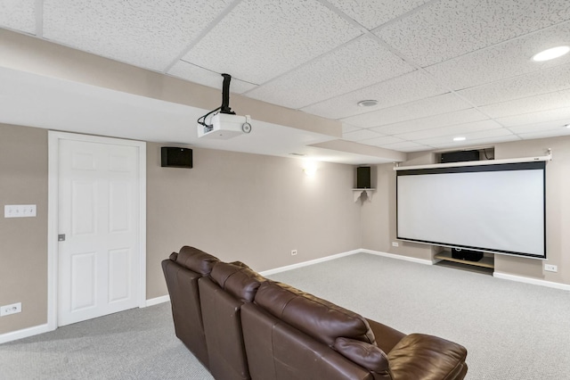 carpeted home theater room featuring a paneled ceiling