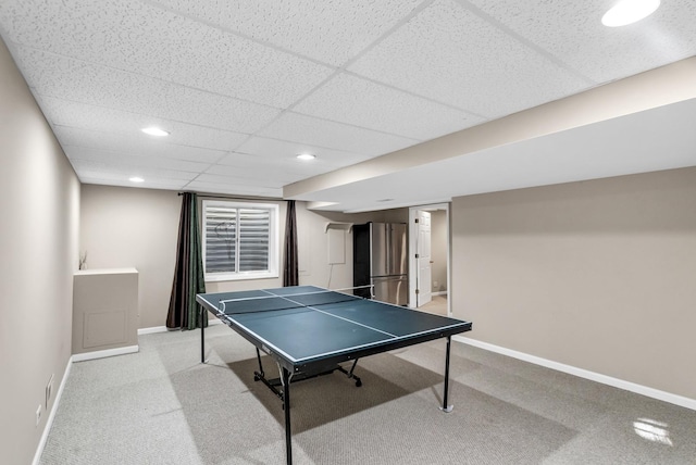 game room featuring light colored carpet and a drop ceiling