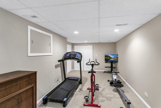 workout area featuring carpet flooring and a drop ceiling