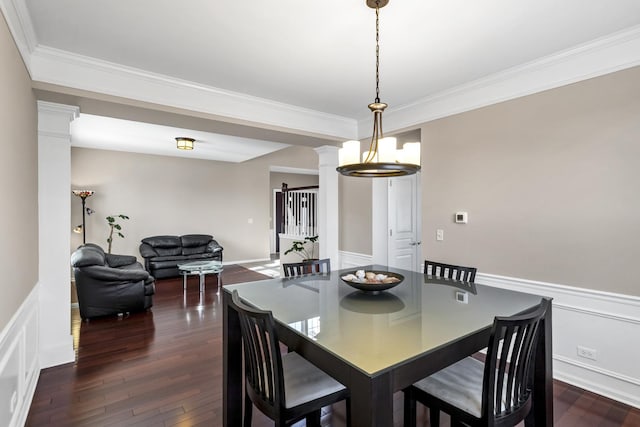 dining space featuring decorative columns, crown molding, and dark hardwood / wood-style floors