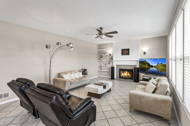 living room featuring a healthy amount of sunlight, a fireplace, and light tile patterned flooring