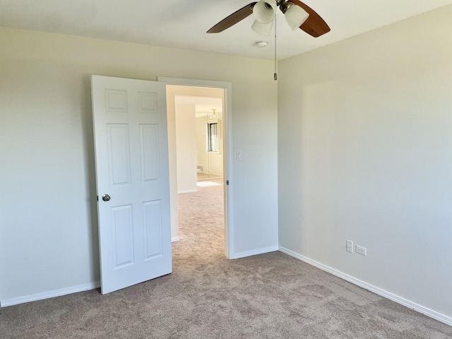 carpeted empty room featuring ceiling fan