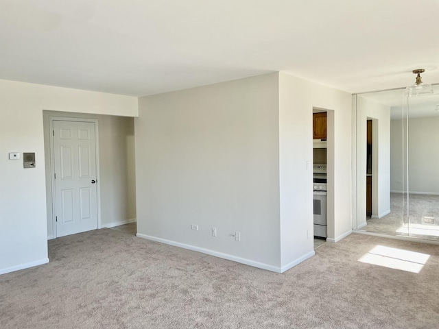 spare room featuring light colored carpet