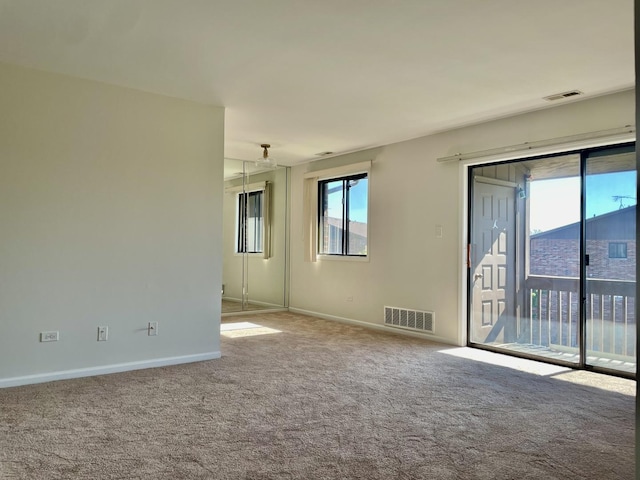 spare room with light colored carpet