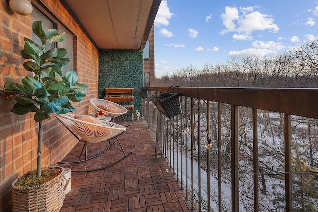 view of snow covered back of property