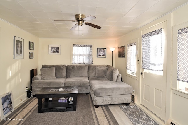 living room featuring ceiling fan, a baseboard radiator, and carpet