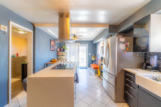 kitchen featuring ceiling fan, black electric stovetop, island exhaust hood, and light tile patterned flooring