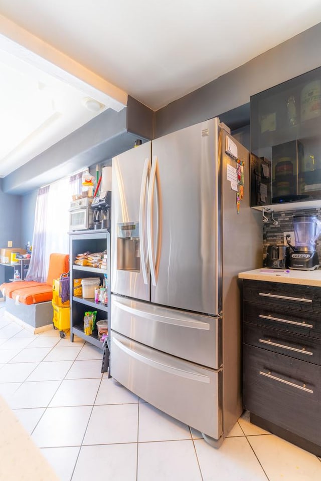 kitchen featuring stainless steel fridge and light tile patterned flooring