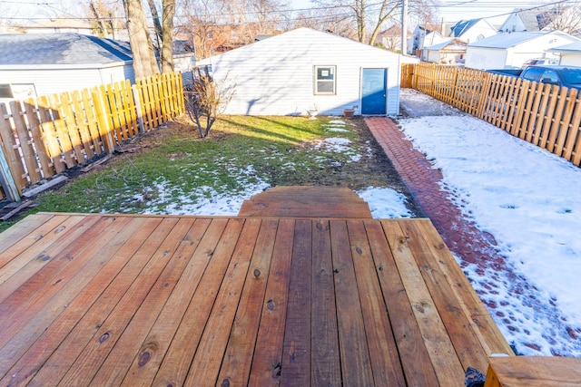 snow covered deck with an outbuilding and a yard