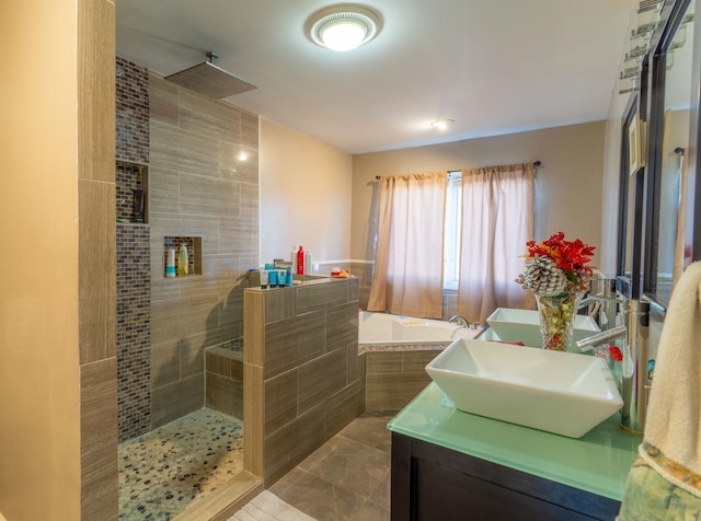 bathroom featuring vanity and independent shower and bath