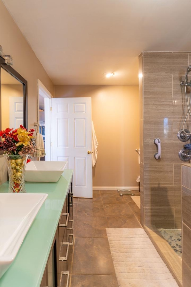 bathroom featuring tiled shower and vanity