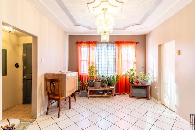 interior space featuring light tile patterned floors, a chandelier, and a textured ceiling