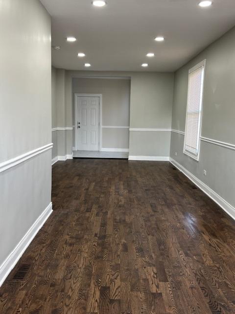 empty room featuring dark hardwood / wood-style flooring