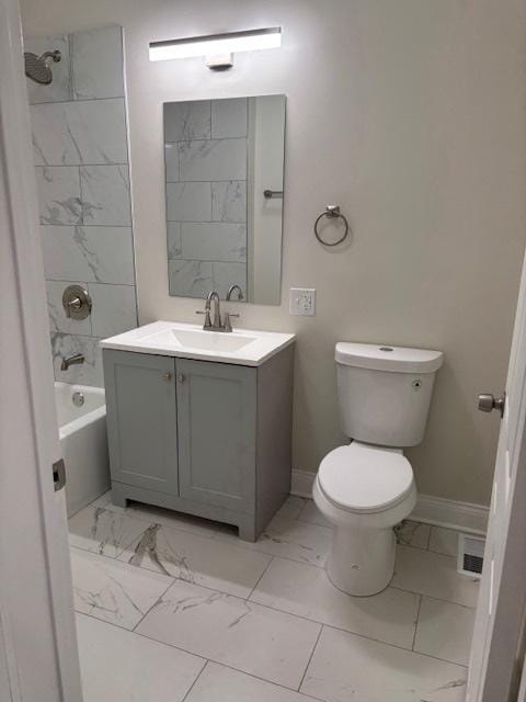 full bathroom with toilet, vanity, and tiled shower / bath