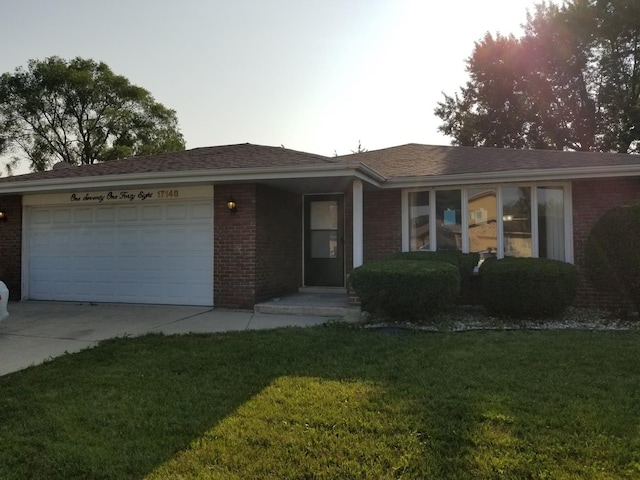 single story home with a front yard and a garage