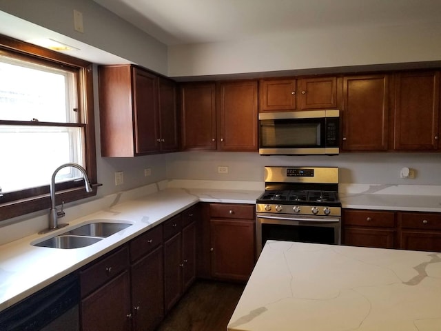 kitchen featuring dark wood-type flooring, appliances with stainless steel finishes, and sink