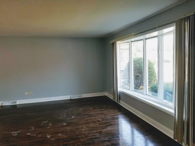 unfurnished room with dark hardwood / wood-style floors