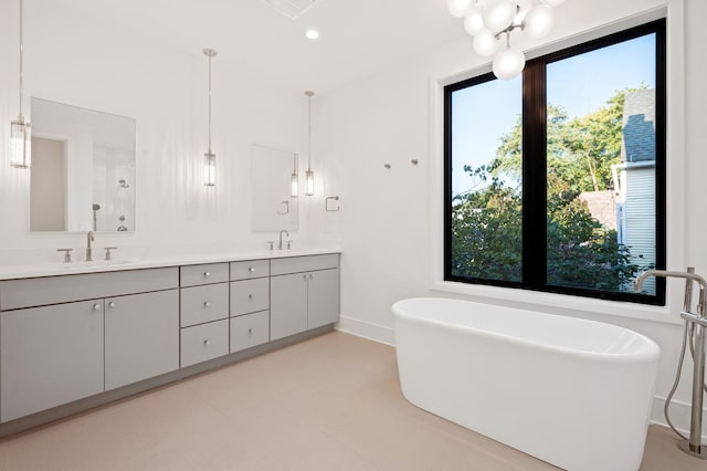 bathroom with vanity and a tub