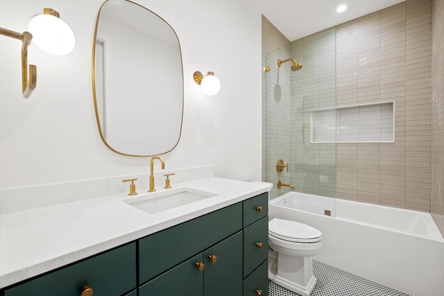 full bathroom featuring tiled shower / bath combo, vanity, toilet, and tile patterned flooring