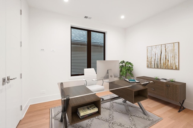 office area with light hardwood / wood-style floors