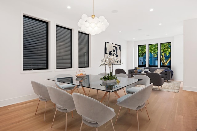 dining area with a chandelier and light hardwood / wood-style floors