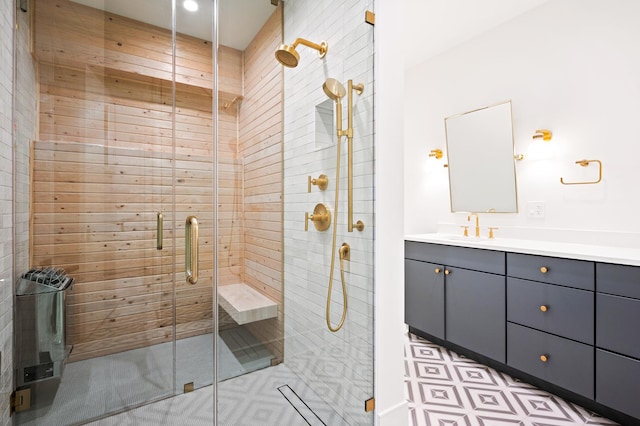 bathroom with vanity and a shower with door