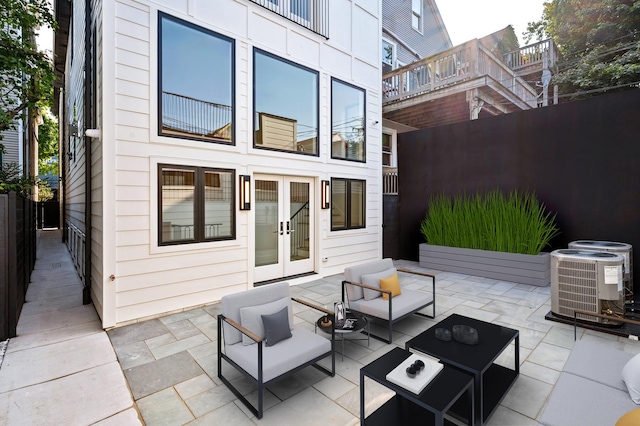 view of patio / terrace with outdoor lounge area, central AC unit, and french doors