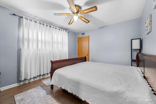 bedroom featuring hardwood / wood-style floors and ceiling fan