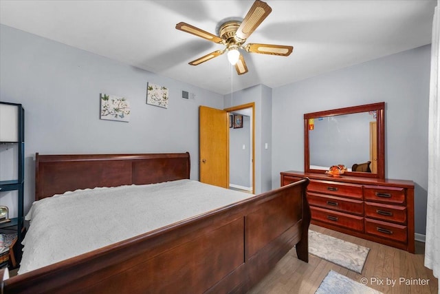 bedroom with light wood-type flooring and ceiling fan