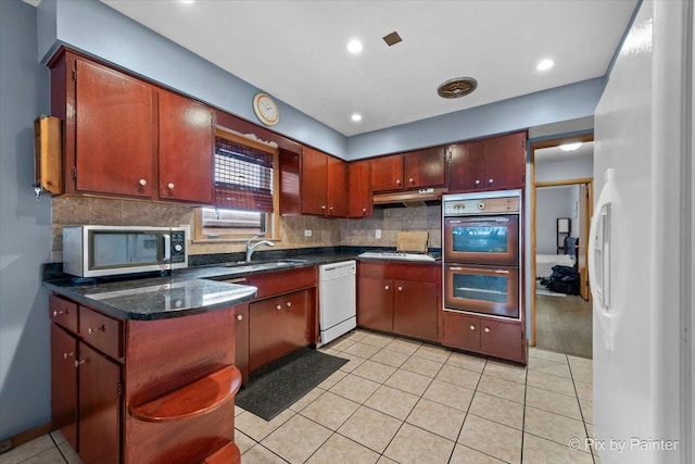 kitchen with sink, decorative backsplash, stainless steel appliances, and light tile patterned flooring