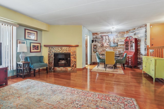 living room featuring hardwood / wood-style flooring and a brick fireplace