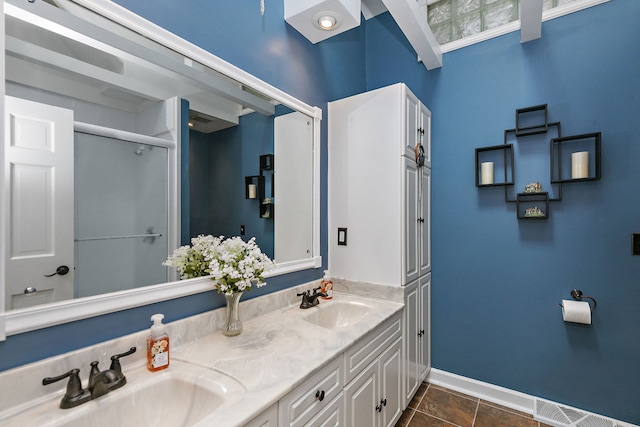 bathroom with vanity, tile patterned flooring, and a shower with shower door