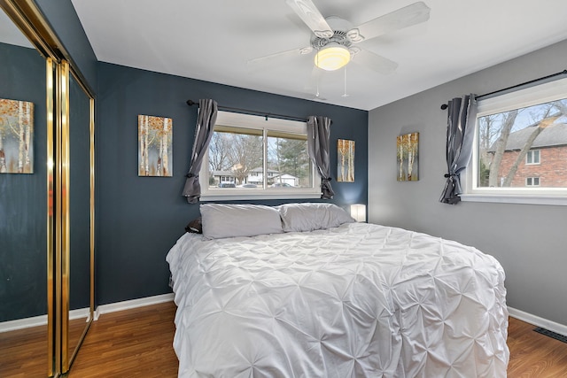 bedroom featuring hardwood / wood-style floors, ceiling fan, and a closet