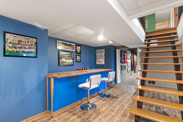 bar featuring a paneled ceiling