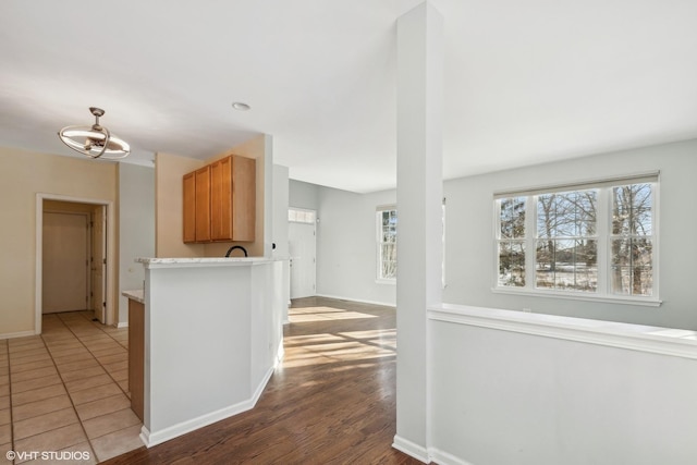 kitchen featuring wood-type flooring and kitchen peninsula