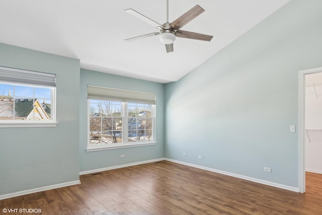 unfurnished room with hardwood / wood-style flooring, vaulted ceiling, and ceiling fan