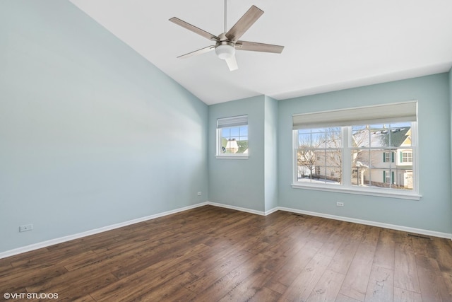 empty room with lofted ceiling, dark hardwood / wood-style floors, and ceiling fan