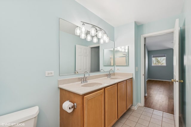 bathroom with vanity, tile patterned floors, and toilet