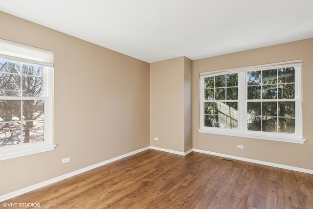 spare room with hardwood / wood-style floors